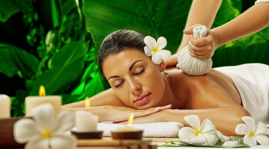 A guest relaxing during a herbal compress massage