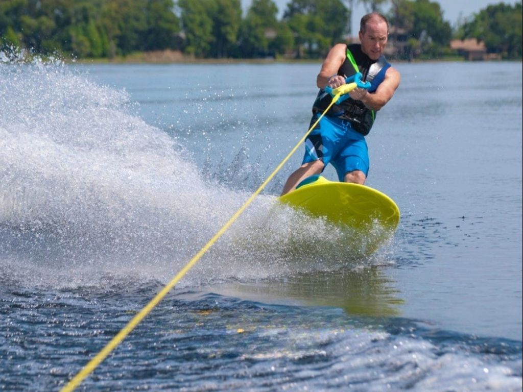 A rider standing on a ZUP board towed behind a boat