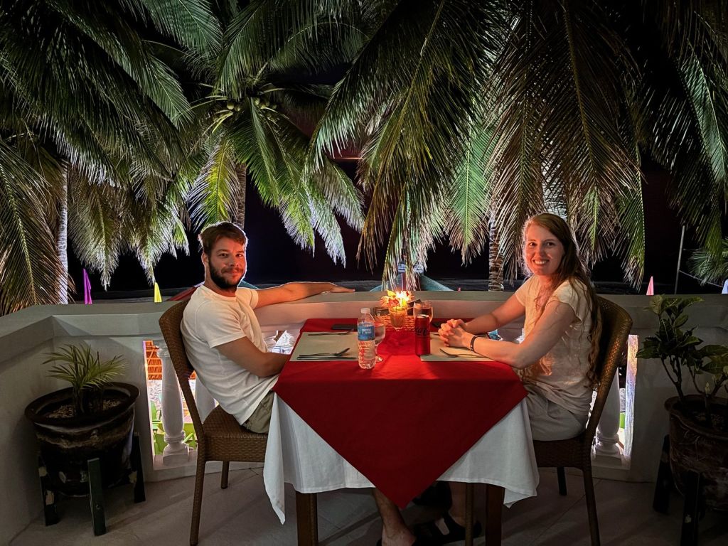 A candlelit dinner for two under the palms