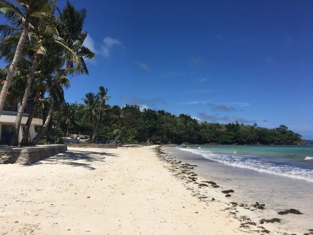 A long white beach curving into the distance
