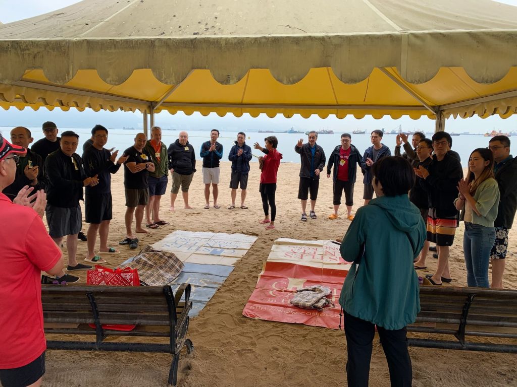 A company group gathered on the beach for team building