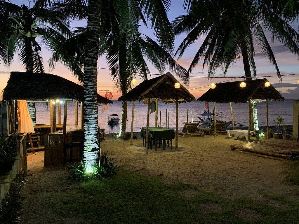 The beach garden and bar lit up at dusk