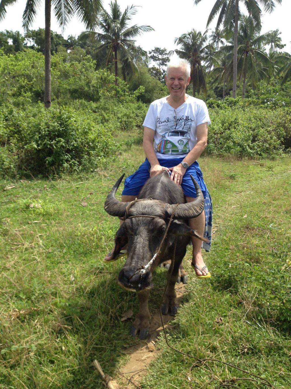A guest riding a carabao through the fields