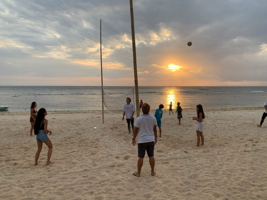 Beach volleyball at sunset