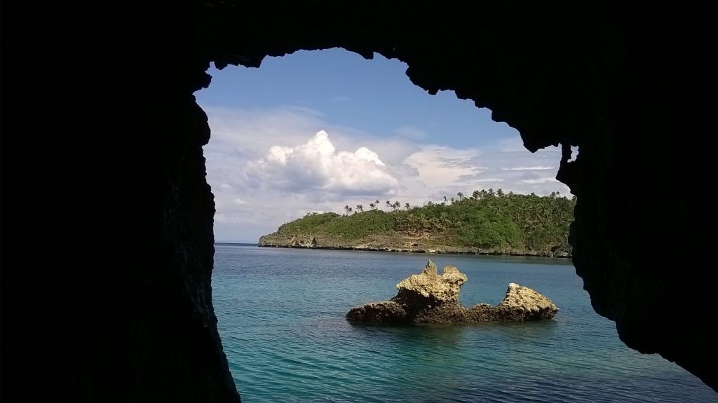 Looking out from a sea cave to a rocky islet