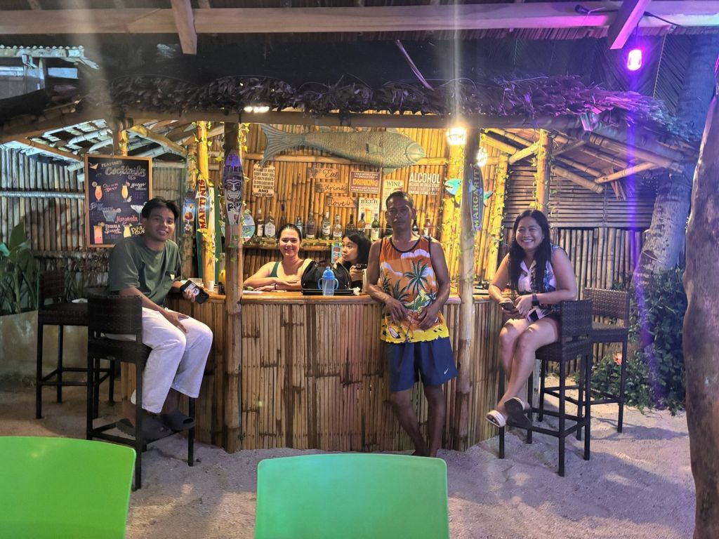 Guests at the Tiki Beach Bar at night