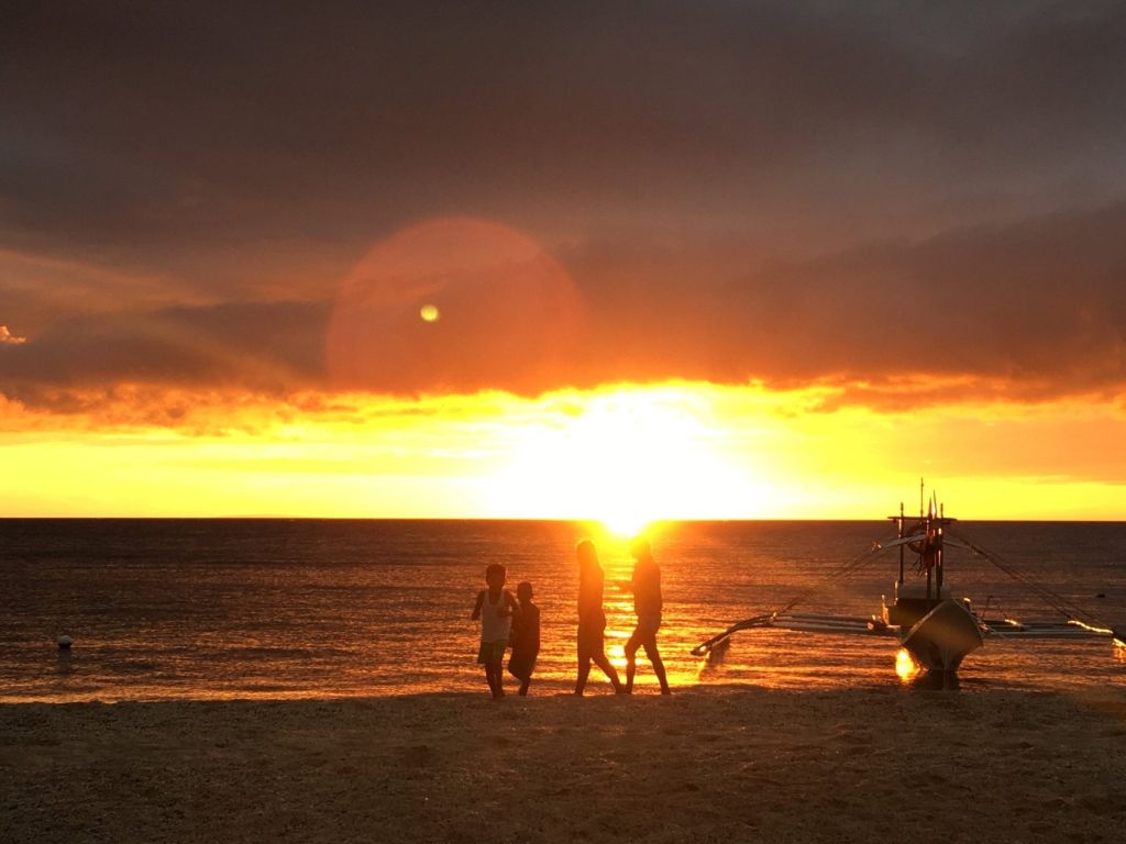 A family on the beach at sunset