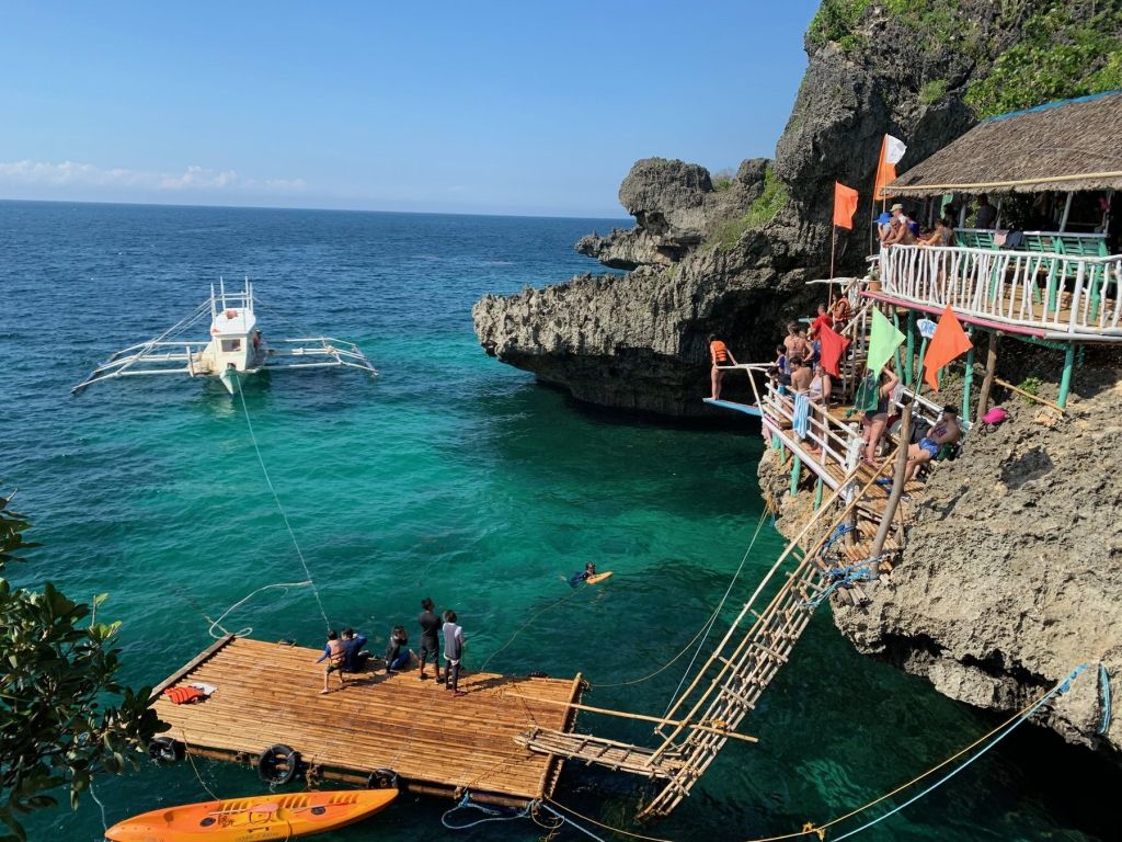 The jungle cliff jump platforms above turquoise water