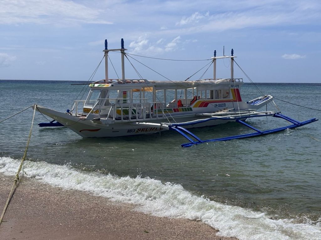 Our private bangka for the Romblon island tour, moored off the beach
