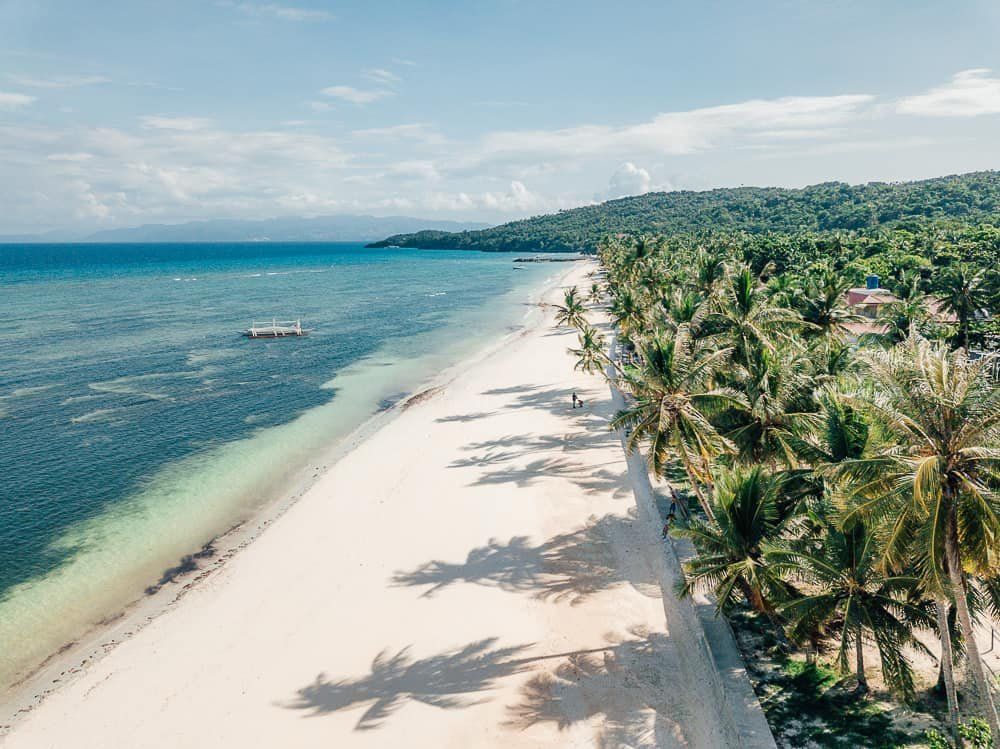 Aerial view of a long white beach on Carabao Island
